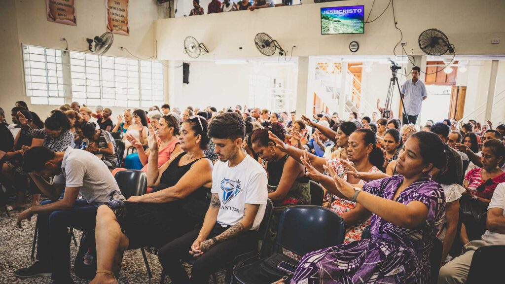 Believers praying together during a Sunday church service in Havana, Cuba.
