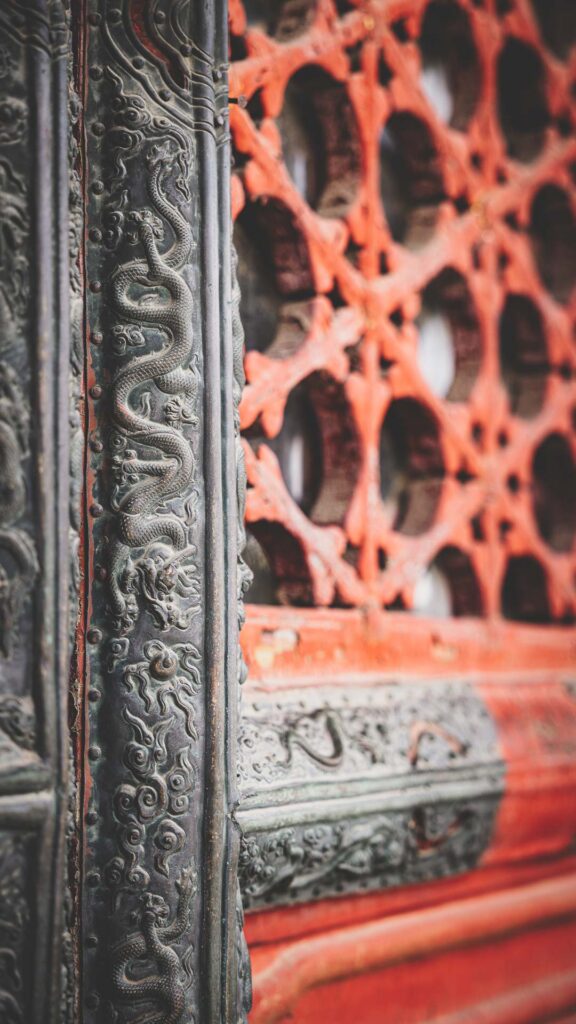 Close-up of ornate dragon carvings and traditional architectural details at the Forbidden City in Beijing, China.