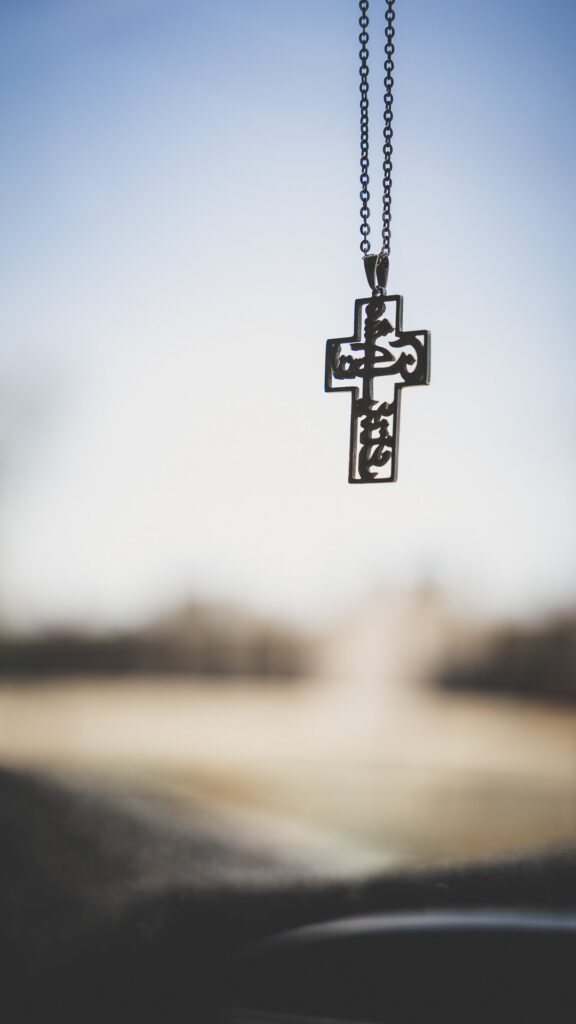 Christian cross hanging inside a vehicle while traveling through Iraq.