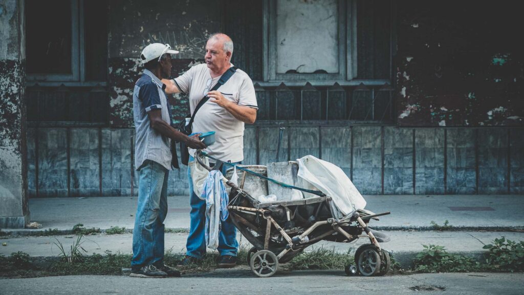 Ministry team member speaking with a local man during community outreach in Cuba.