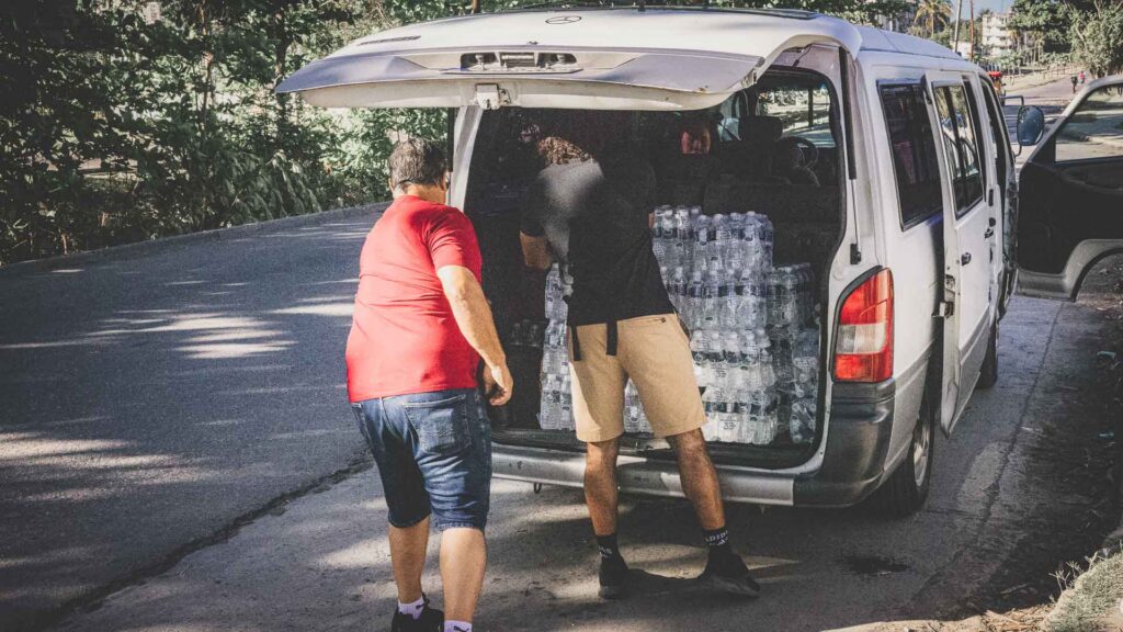 Volunteers loading bottled water and supplies for compassion evangelism outreach in Cuba.