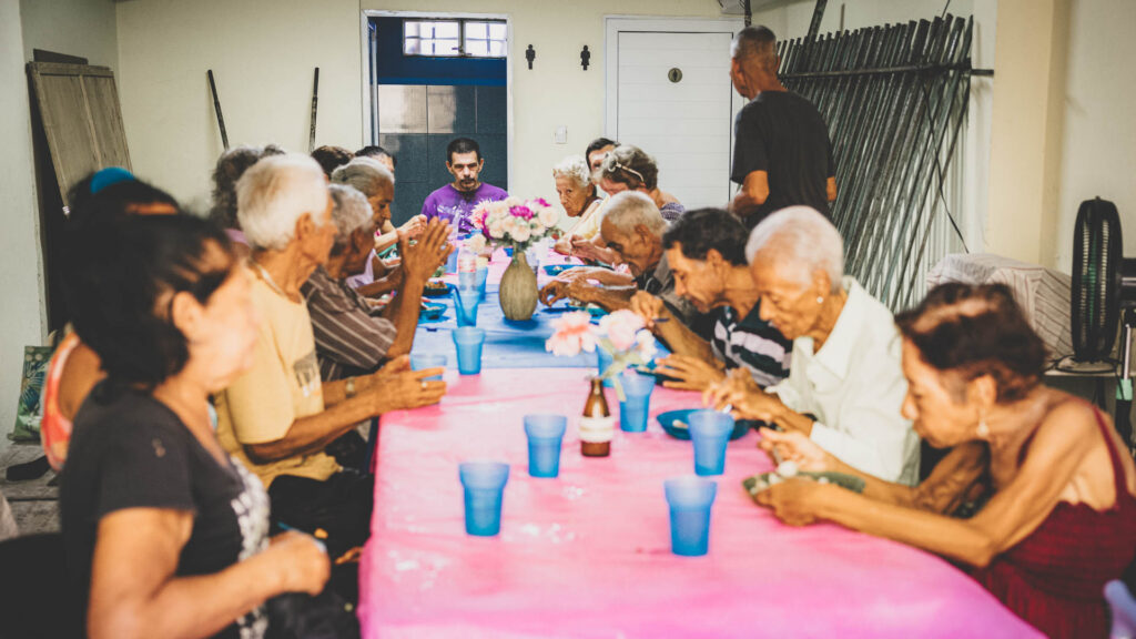 Older adults sharing a meal during a community food outreach in Cuba.