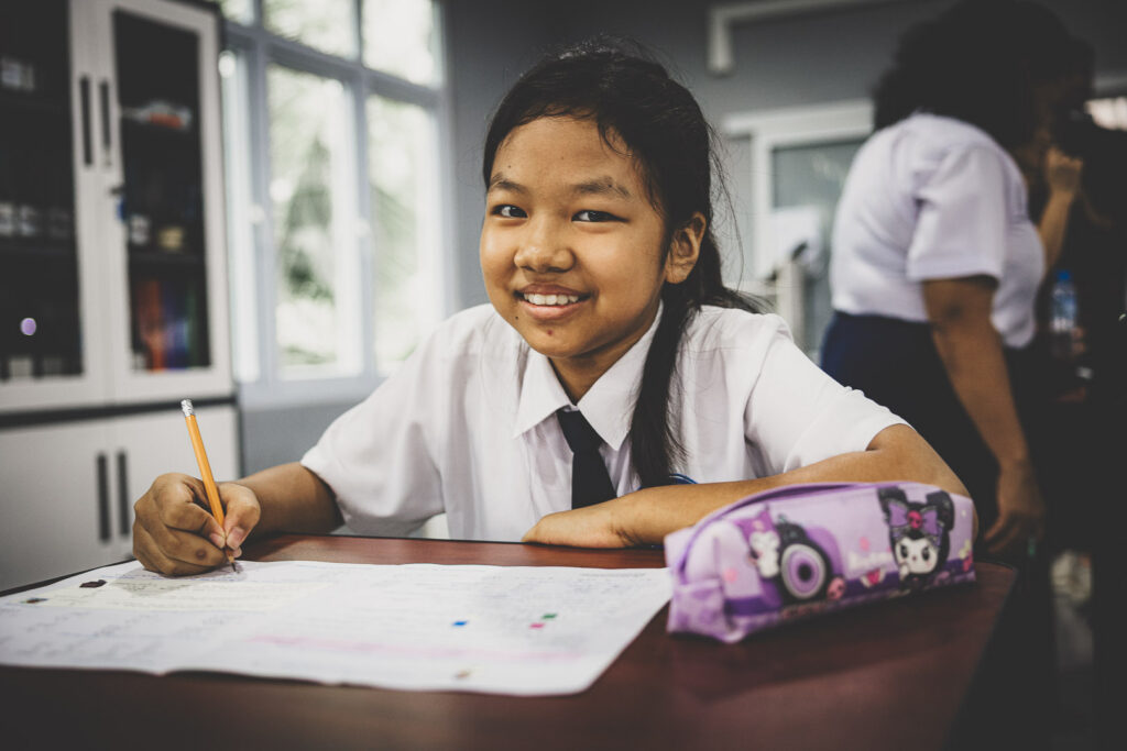 Student completing schoolwork at Empower International School in Myanmar.