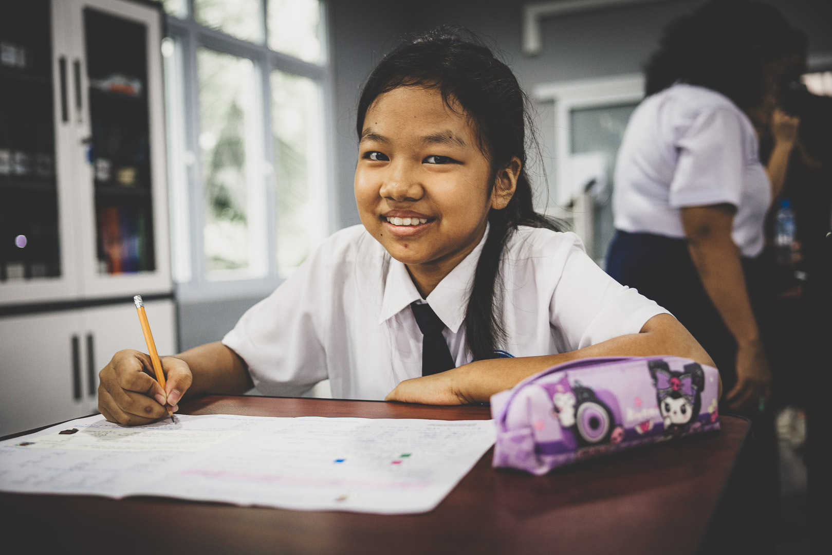 Student completing schoolwork at Empower International School in Myanmar.