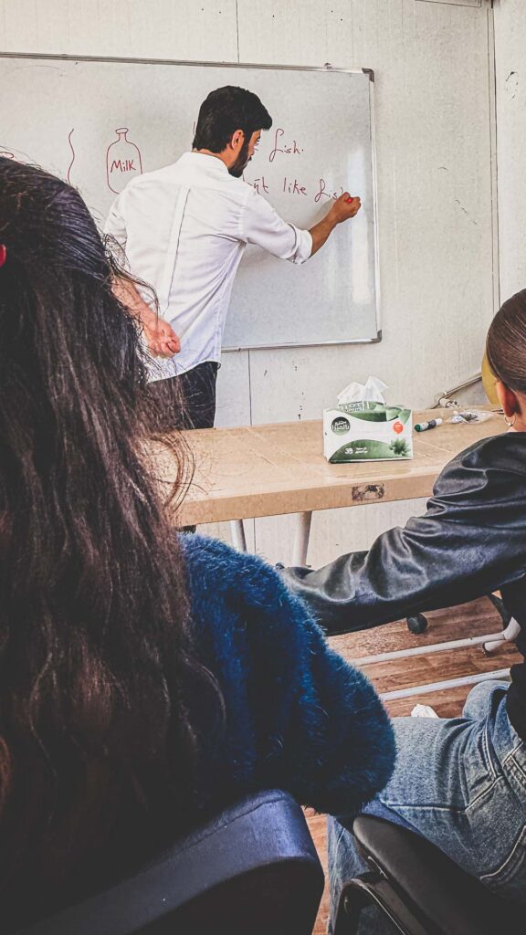 Refugee students participating in an English language class in Iraq.
