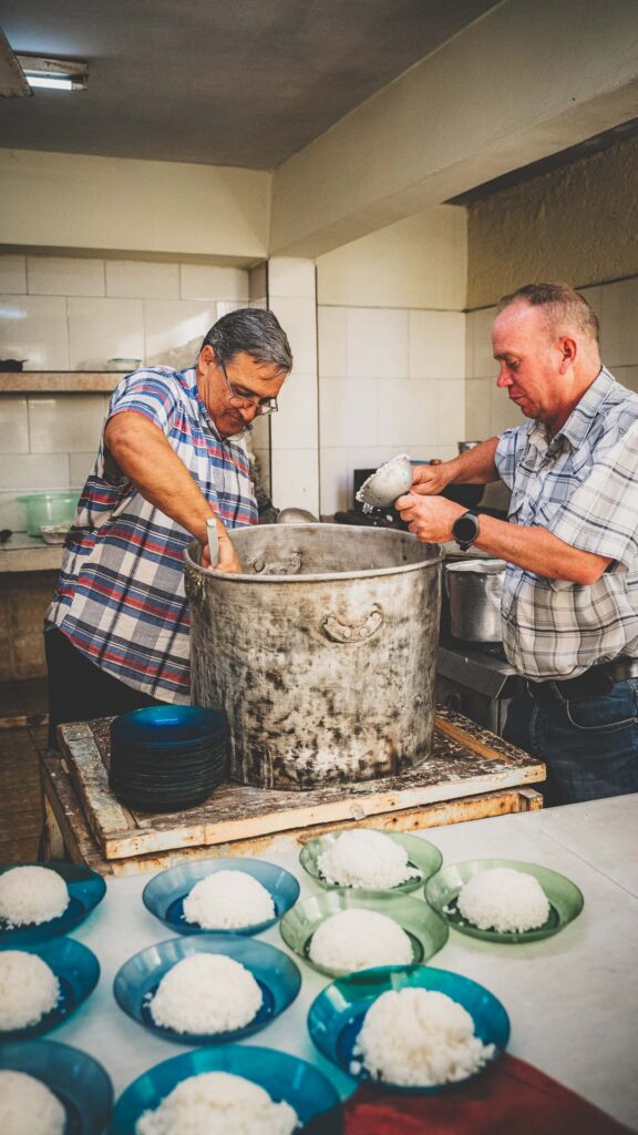 Volunteers preparing plates of rice for a food outreach in Cuba.