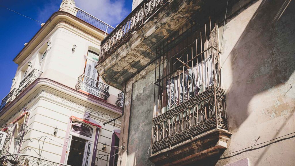Historic buildings with wrought iron balconies and weathered façades in Old Havana, Cuba.