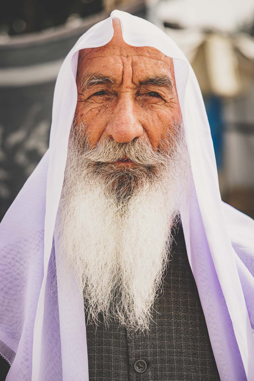 Portrait of an elderly Kurdish man in Iraq wearing traditional clothing.