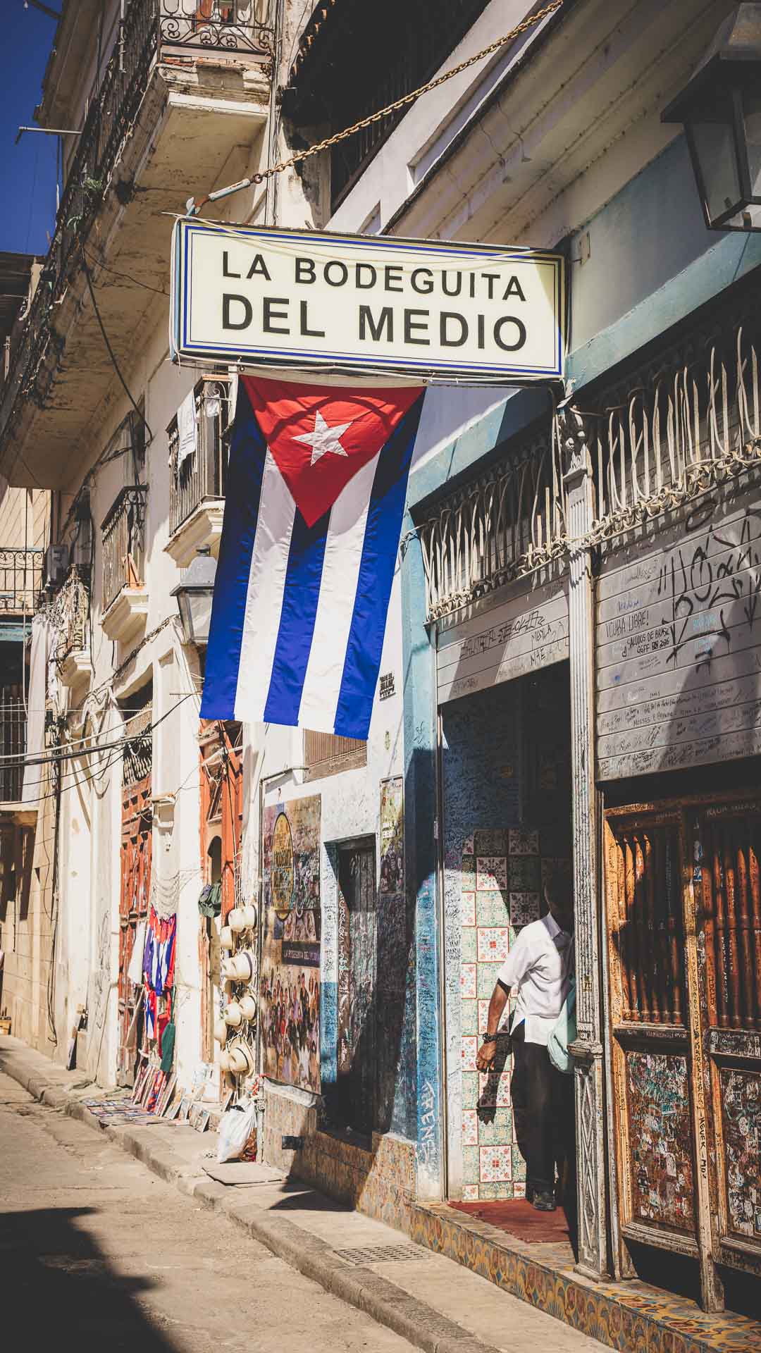 Entrance to La Bodeguita del Medio with a Cuban flag in Old Havana, Cuba.