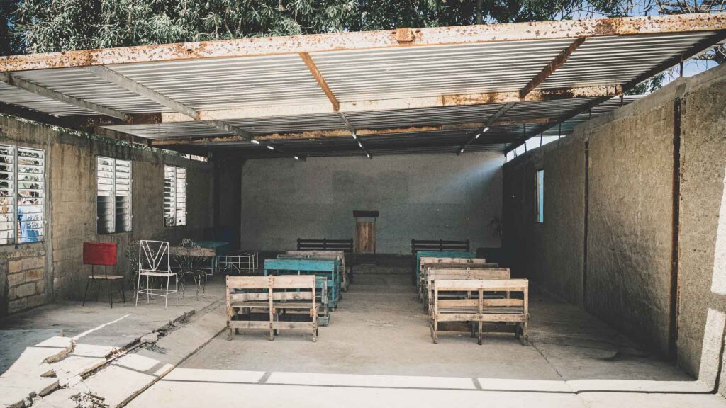 Simple local church building with wooden benches and corrugated roof in Havana, Cuba.