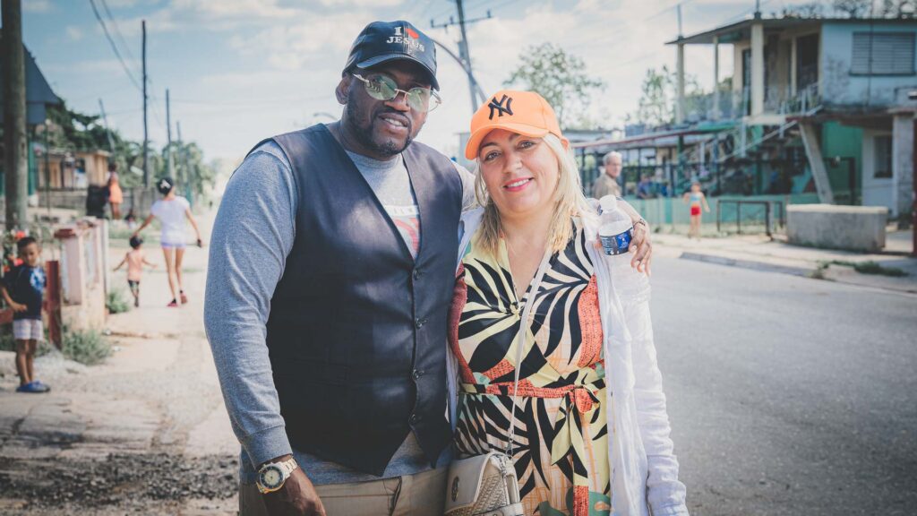 Two local church pastors standing together on a residential street in Cuba.