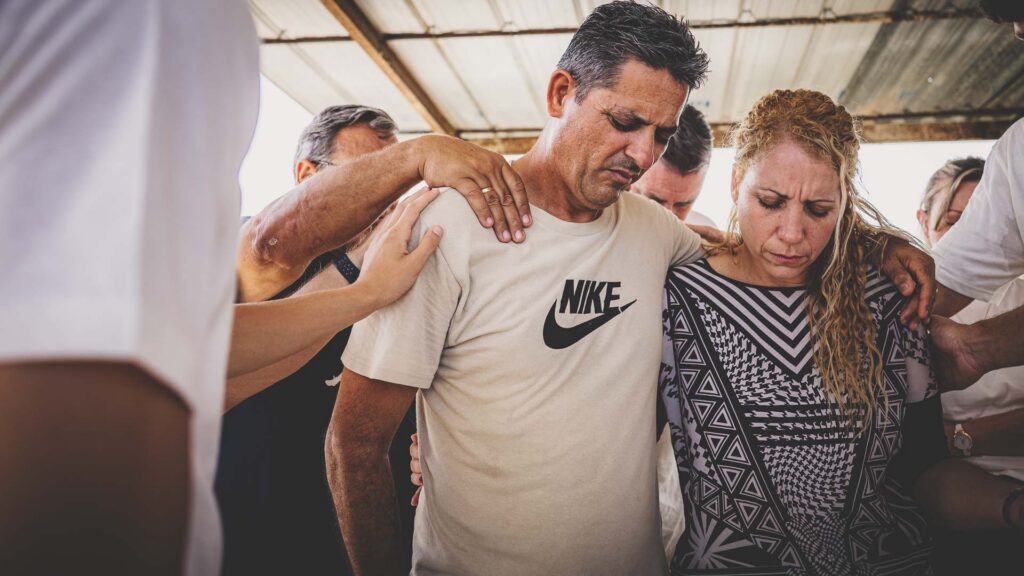 Local pastors in Cuba surrounded by fellow believers praying for them.