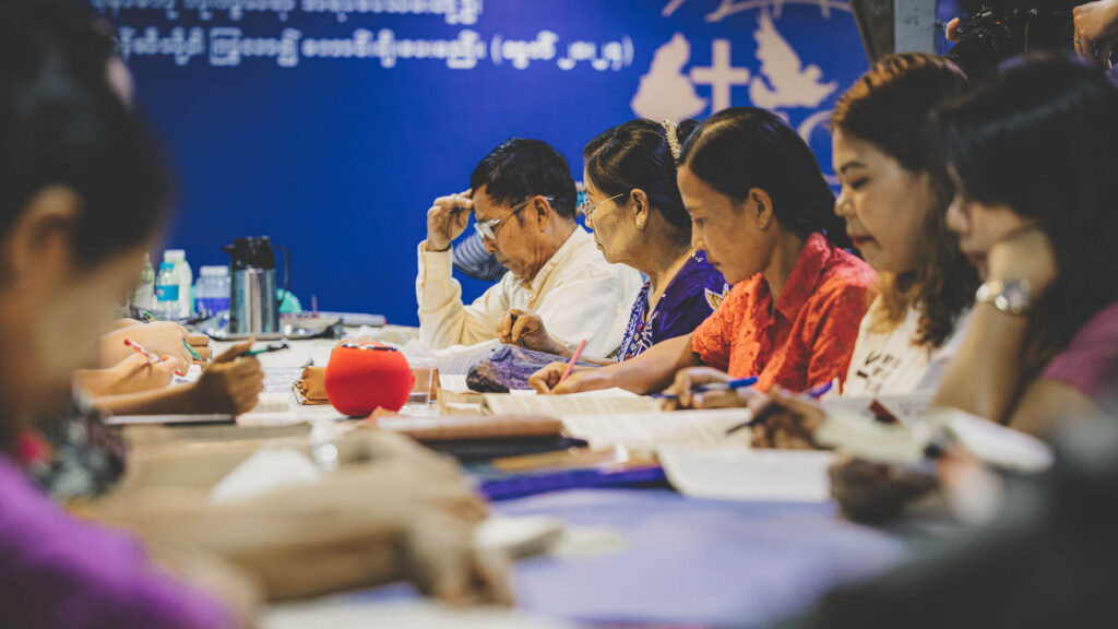 Christian leaders studying ABC curriculum together during Bible and leadership training in Myanmar.