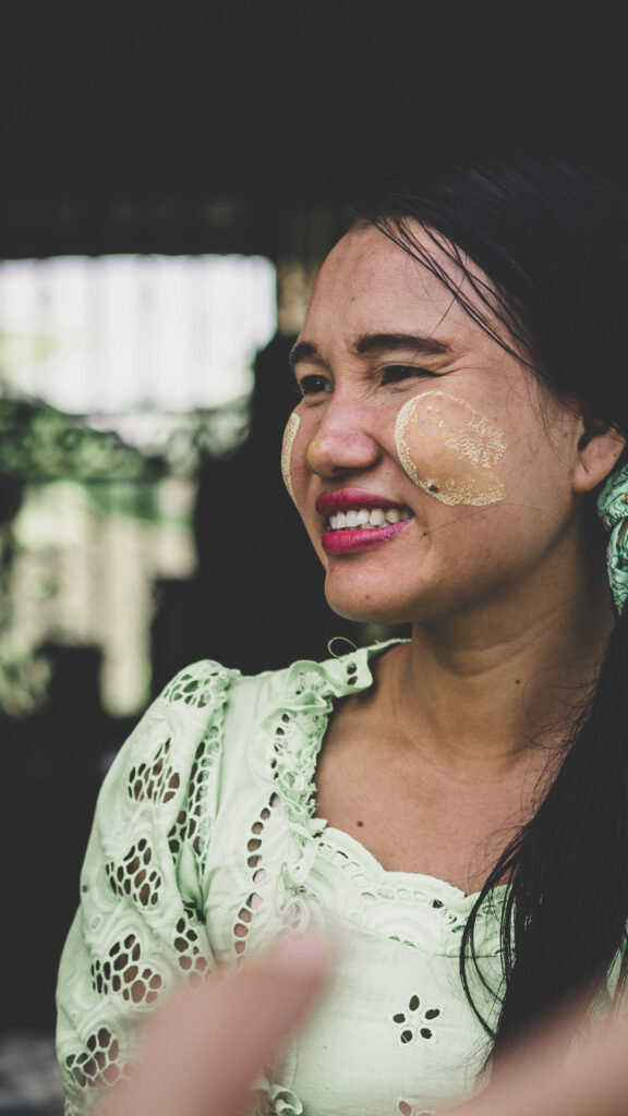 Woman in Yangon, Myanmar, wearing traditional thanaka on her cheeks.