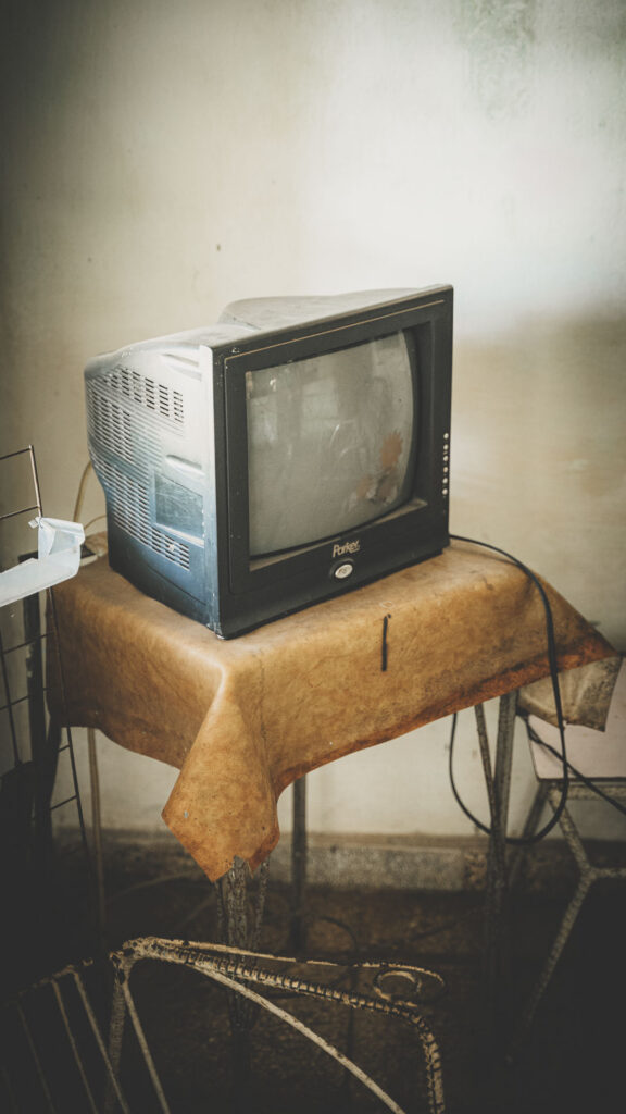 Old television sitting on a small table inside a home in Cuba.