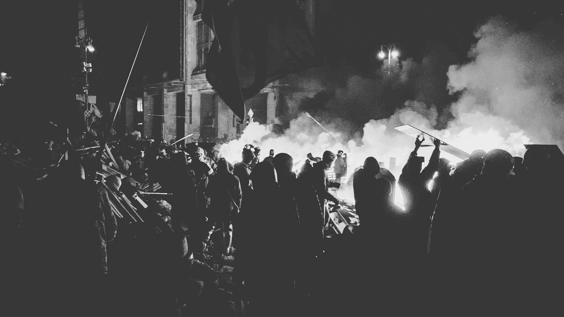 Crowds gathered amid fires and smoke during civil unrest in Iran.
