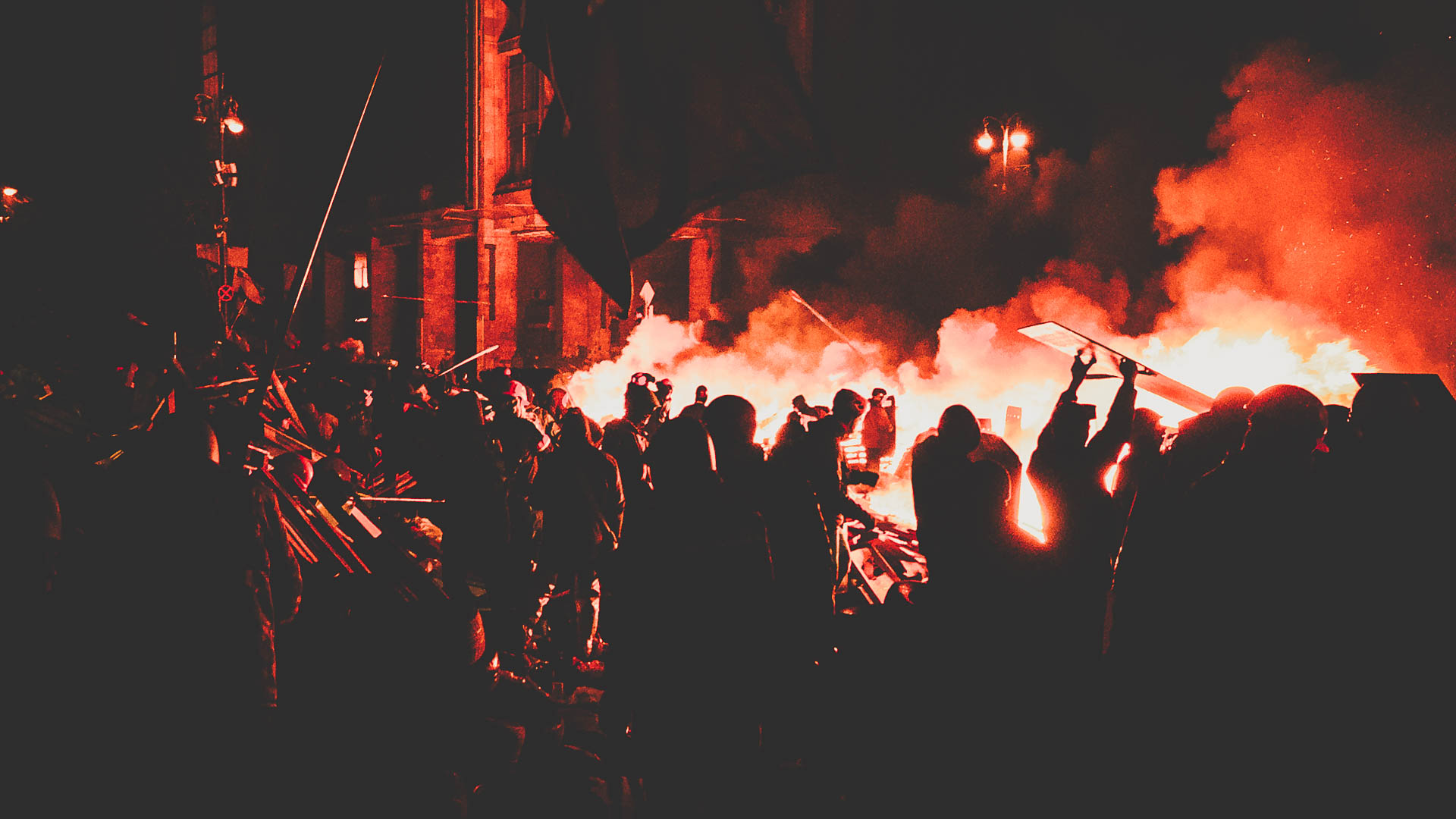 Crowds gathered amid fires and smoke during civil unrest in Iran.