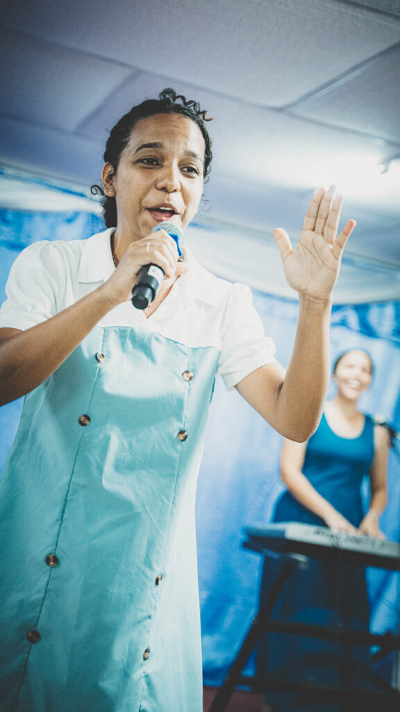 Worship leader singing during a local church service in Cuba.