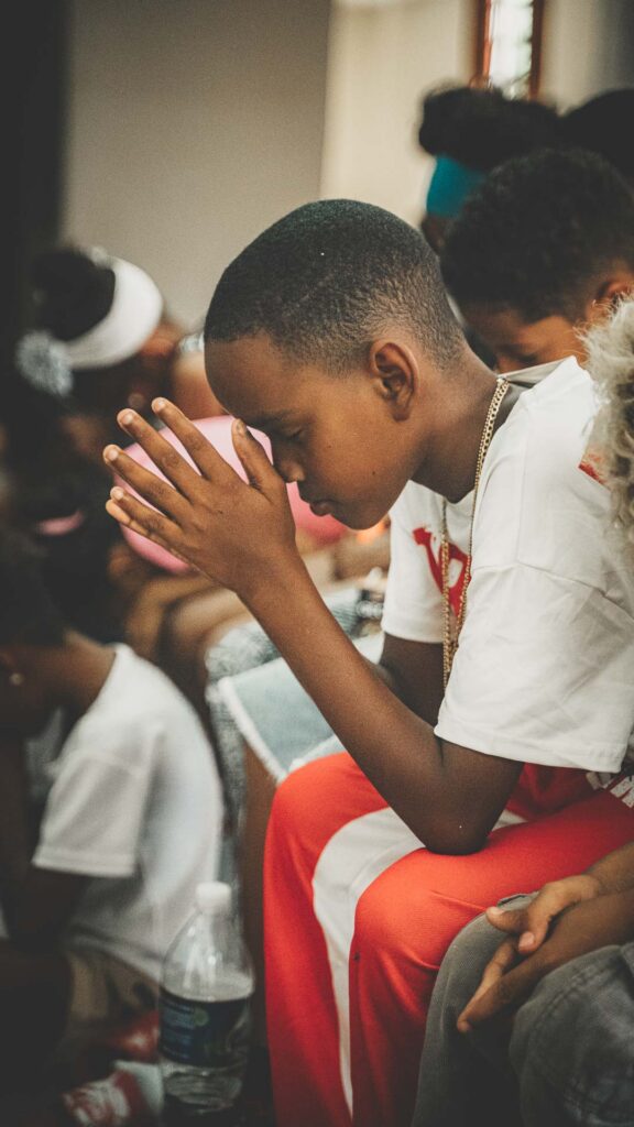 Young person praying during a local church youth outreach in Cuba.
