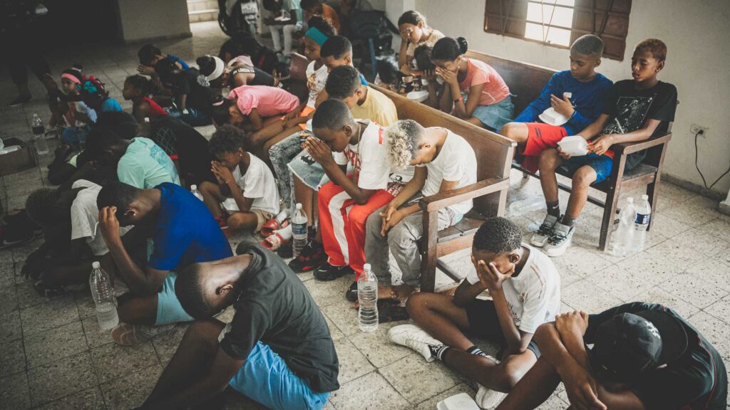 Young people praying together during a sports outreach at a local church in Cuba.
