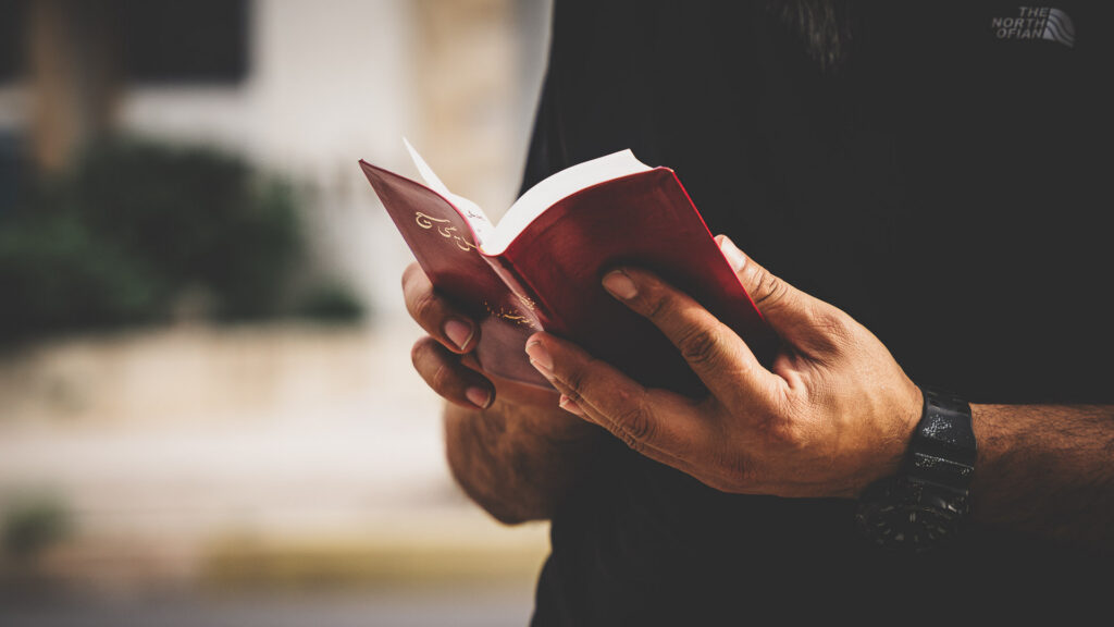 Person reading a Farsi-language Bible distributed through Bibles Across Borders.
